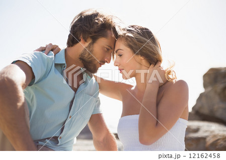 Gorgeous couple embracing at the coast Gorgeous couple embracing at the coast 12162458