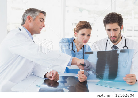 Doctors sitting together with x-rays 12162604