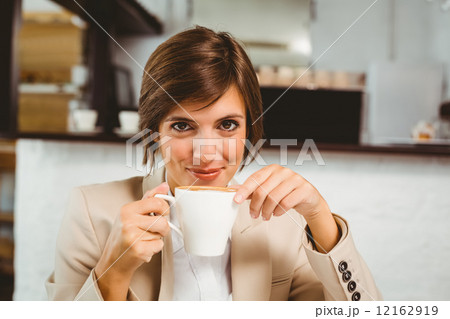 Pretty businesswoman enjoying her coffee Pretty businesswoman enjoying her coffee 12162919