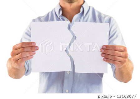 Man holding torn white paper Man holding torn white paper 12163077