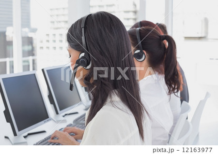 Employee's typing on their computers Employee's typing on their computers 12163977