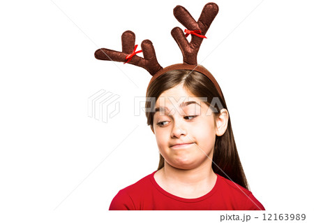 Festive little girl wearing antlers Festive little girl wearing antlers 12163989