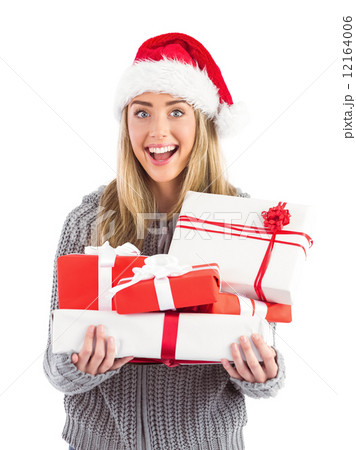 Festive blonde holding pile of gifts 12164006