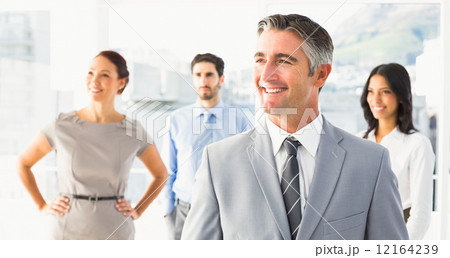 Smiling businessman and his co-workers 12164239