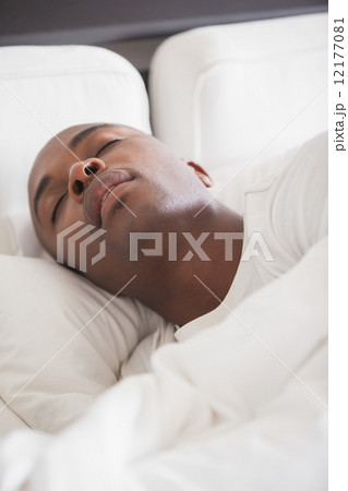 Peaceful man sleeping in bed Peaceful man sleeping in bed 12177081