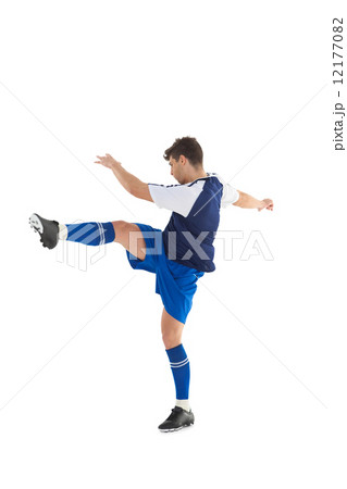 Football player in blue jersey kicking Football player in blue jersey kicking 12177082