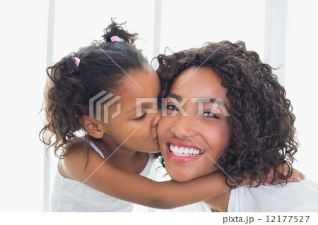 Pretty mother with her daughter kissing her cheek Pretty mother with her daughter kissing her cheek 12177527