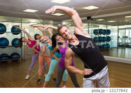 Fitness class led by handsome instructor Fitness class led by handsome instructor 12177642