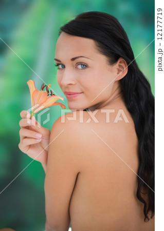 Beautiful nude brunette smelling lily Beautiful nude brunette smelling lily 12177719