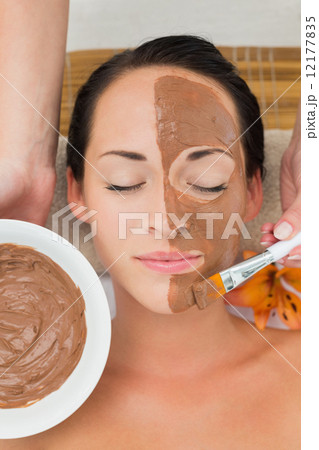 Peaceful brunette getting a mud facial applied Peaceful brunette getting a mud facial applied 12177835