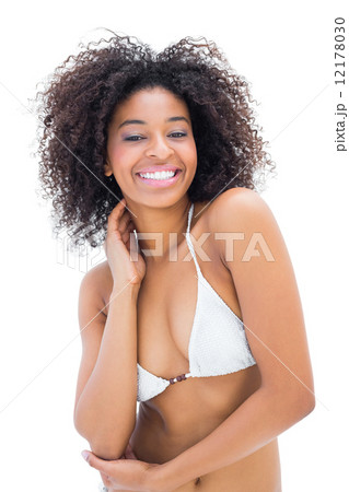 Fit girl in white bikini smiling at camera Fit girl in white bikini smiling at camera 12178030