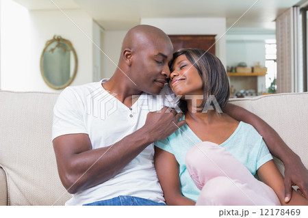 Happy couple relaxing on the couch Happy couple relaxing on the couch 12178469