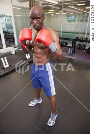 Muscular boxer in defensive stance in health club Muscular boxer in defensive stance in health club 12178554