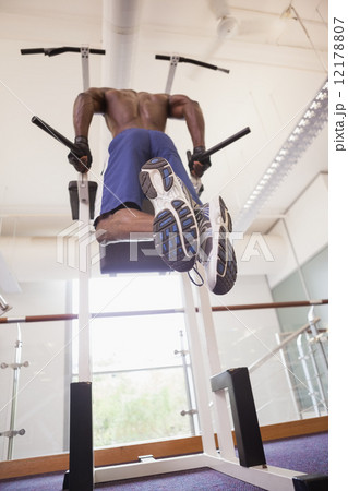 Male body builder doing pull ups at the gym 12178807