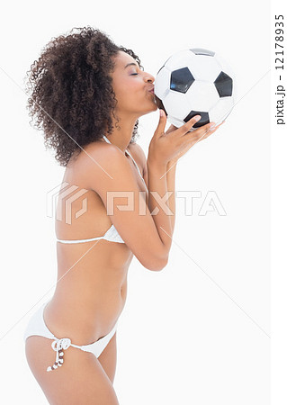 Athletic girl in white bikini kissing football Athletic girl in white bikini kissing football 12178935