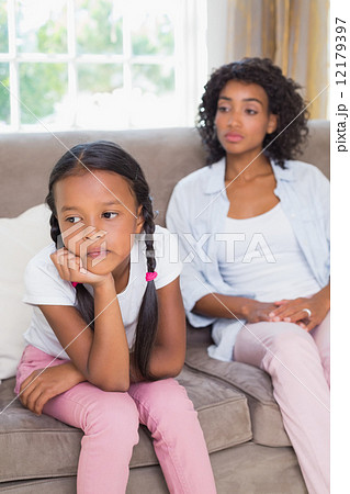 Pretty mother sitting on couch after an argument with daughter 12179397