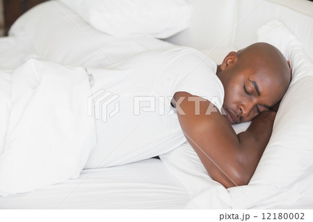 Peaceful man sleeping in bed Peaceful man sleeping in bed 12180002