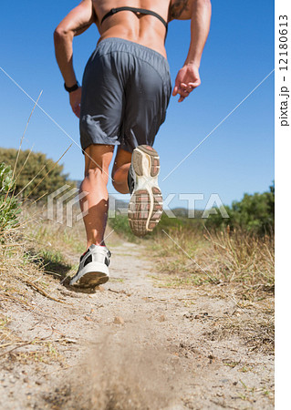 Shirtless man jogging with heart rate monitor around chest Shirtless man jogging with heart rate monitor around chest 12180613