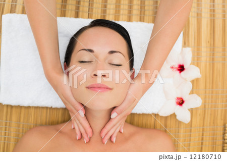Peaceful brunette enjoying a facial massage Peaceful brunette enjoying a facial massage 12180710