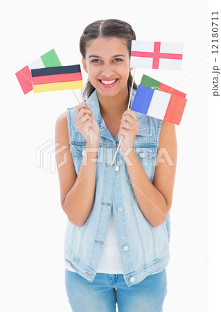 Pretty brunette holding various european flags 12180711