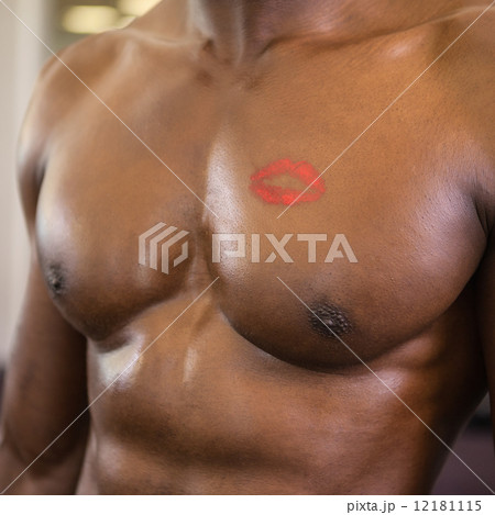 Shirtless muscular man with lipstick mark on chest Shirtless muscular man with lipstick mark on chest 12181115