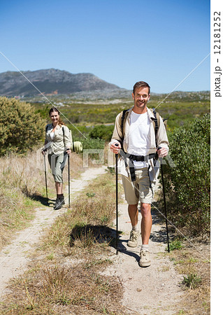 Happy hiking couple walking on country trail 12181252
