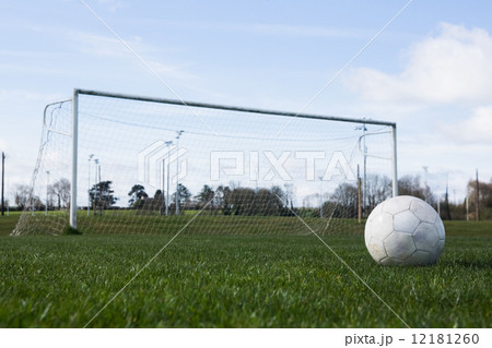 Football on an empty pitch in front of goal 12181260