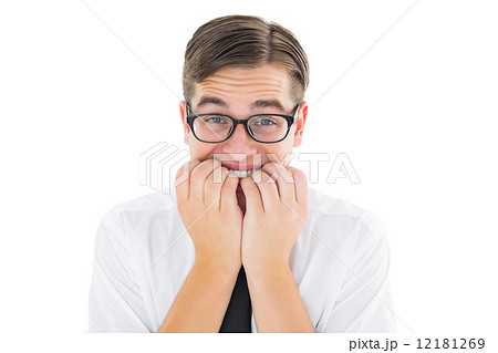 Geeky businessman looking nervously at camera Geeky businessman looking nervously at camera 12181269