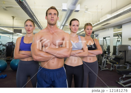 Serious fitness class posing together 12181276