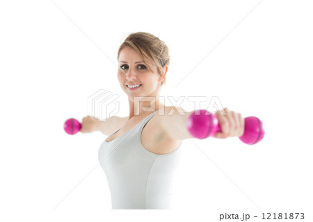 Smiling young woman with dumbbells 12181873