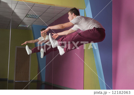 Cool break dancer mid air doing the splits in front of mirror Cool break dancer mid air doing the splits in front of mirror 12182063