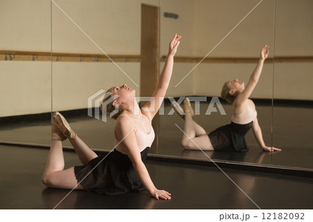 Beautiful ballerina dancing in front of mirror Beautiful ballerina dancing in front of mirror 12182092