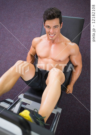 Male weightlifter doing leg presses in gym Male weightlifter doing leg presses in gym 12182108