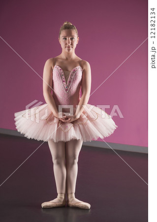 Graceful ballerina standing in first position Graceful ballerina standing in first position 12182134