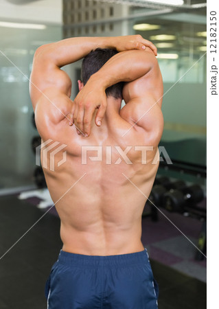 Rear view of a bodybuilder in gym Rear view of a bodybuilder in gym 12182150