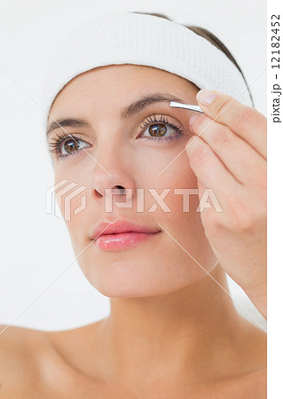 Hand applying eyeshadow to beautiful woman 12182452