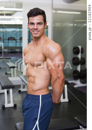 Shirtless muscular man posing in gym Shirtless muscular man posing in gym 12182904