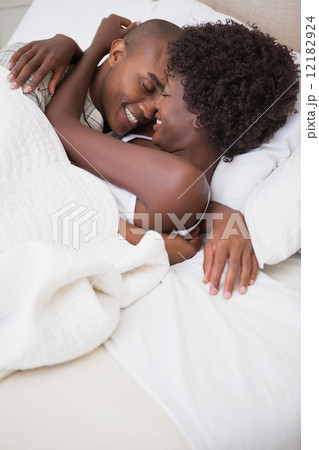 Happy couple in bed together Happy couple in bed together 12182924