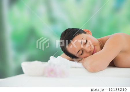 Beautiful brunette relaxing on massage table Beautiful brunette relaxing on massage table 12183210