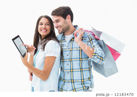 Attractive young couple with shopping bags and tablet pc Attractive young couple with shopping bags and tablet pc 12183470