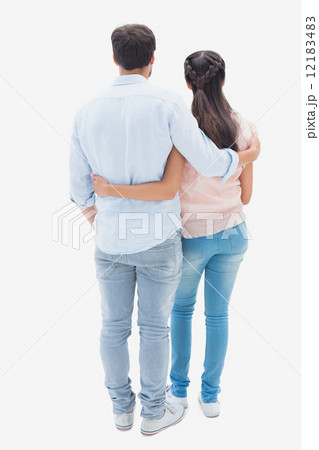 Attractive young couple standing with arms around Attractive young couple standing with arms around 12183483