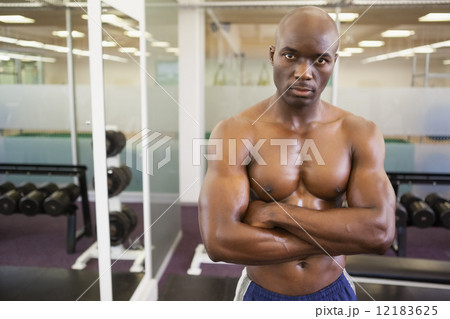 Serious shirtless muscular man in gym Serious shirtless muscular man in gym 12183625