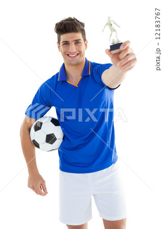 Football player in blue jersey holding winners trophy Football player in blue jersey holding winners trophy 12183767