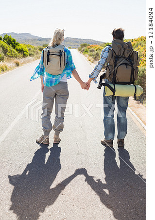 Attractive couple standing on the road holding hands Attractive couple standing on the road holding hands 12184094