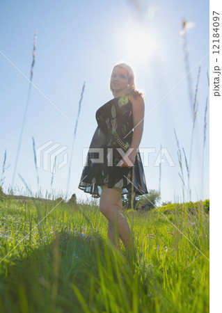 Pretty blonde in sundress smiling at camera 12184097