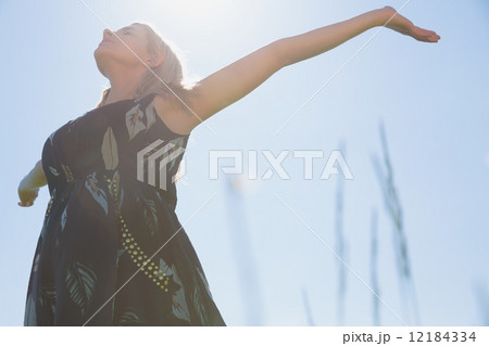 Pretty blonde in sundress standing with arms out Pretty blonde in sundress standing with arms out 12184334