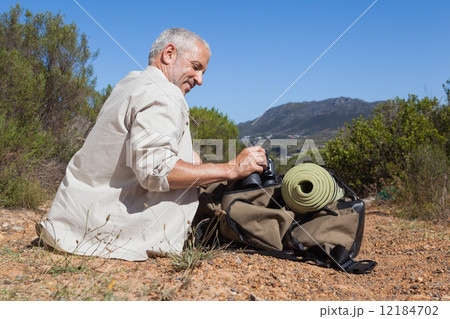 Hiker taking a break on country trail 12184702