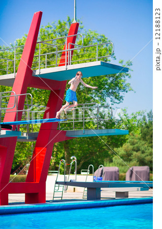 Boy jumping into a pool 12188123
