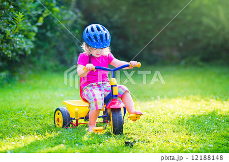 Toddler girl on a bike 12188148