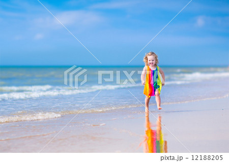 Little girl running on a beach Little girl running on a beach 12188205